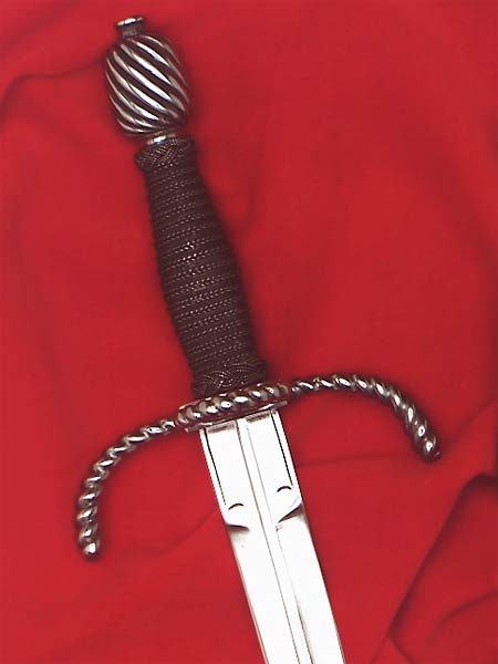 Writhen Parrying Dagger #159 matches the Writhen Rapier is style with twisted arms of the guard and ring bent forward towards the blade tip and a barrel shaped pommel also writhed in detail.